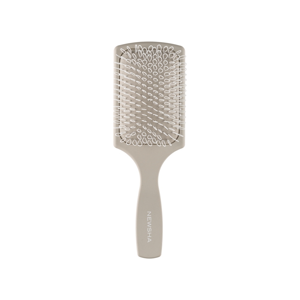 Newsha Paddle Brush in Beige mit flexiblem Borstenfeld – professionelle Haarbürste für sanftes Entwirren, Glanz und schonendes Styling.